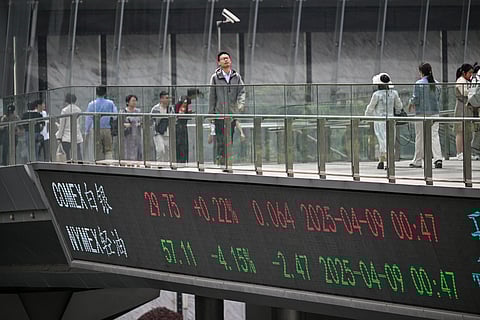 Board on a foot bridge shows the silver futures and financial market informations in Shanghai. US President Donald Trump forged ahead with tariffs of over 100 percent against Chinese goods after Beijing refused to withdraw its retaliation as the world’s biggest economies go head-to-head in a ruinous trade war that has rocked global markets.