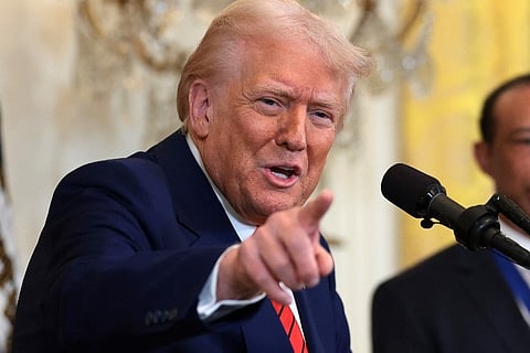 U.S. President Donald Trump, joined by golf legend Tiger Woods, speaks during a reception honoring Black History Month in the East Room of the White House on 20 February 2025 in Washington, DC.