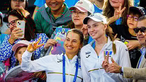 Kazakhstan's Elena Rybakina (R) and Yulia Putintseva (L) pose with fans during their Billie Jean King Cup tie in Brisbane