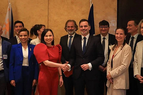Trade and Industry Secretary Cristina Roque (clad in red) shakes hands with Minister Delegate for Foreign Trade and French Nationals Abroad, Laurent Saint-Martin, during the France-Philippines Business Forum in Makati City on Friday. The forum centered on strengthening economic ties and reaffirming cooperation between France and the European Union, amid evolving global trade conditions. Also gracing the event are members of French and EU delegations, including French Ambassador Marie Fontanel (3rd from right).