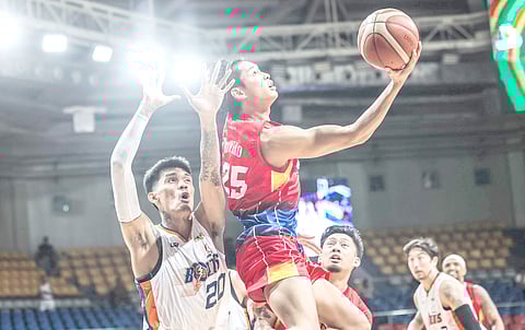 Ricci Rivero of the Phoenix Fuel Masters gets past Raymond Almazan and Meralco Bolts, 109-97, in their PBA Philippine Cup game on Sunday at the Ninoy Aquino Stadium.