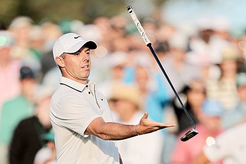 Rory McIlroy tosses his putter after finishing with a six-under-par 66 to post a 12-under total of 204 entering the final round of the Masters Tournament at Augusta National.