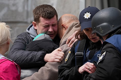 Two men comfort each other as Ukrainian police psychologists provide assistance to local residents following a missile attack in Sumy, northeastern Ukraine, on 13 April 2025, amid the Russian invasion of Ukraine. A Russian ballistic missile attack on Ukraine's northeastern city of Sumy killed at least 31 people and wounded 84 on Palm Sunday, Kyiv said, in another deadly attack on civilians that came after a top US official travelled to Russia.