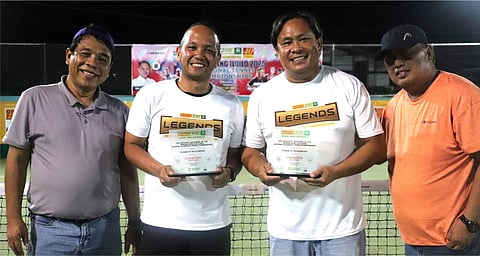 Miru Tupas and Lucien Caiman display their trophies as they pose with Iloilo chief legal officer Dennis Ventilacion (left) and Philta official Joilie Mondragon (right) after topping the Classified B doubles crown in the Semana Sang Iloilo netfest.