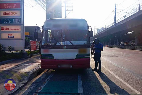 Members from the Metropolitan Manila Development Authority Quick Reaction Unit flag some drivers for various traffic violations along EDSA in Quezon City.