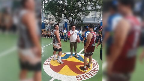 KUYA Choi gives a last-minute pep talk before presiding over the jump ball kicking off a basketball league in Manila.