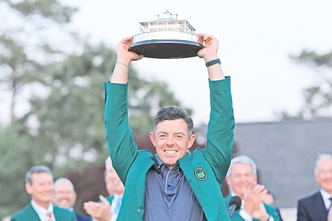 RORY McIlroy raises the trophy following a thrilling playoff win over Justin Rose in the Masters Tournament at Augusta National.