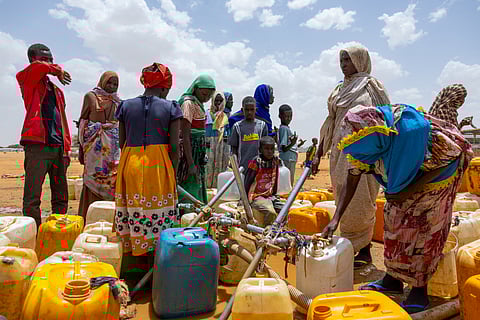 Sudanese refugees fill jerry cans with water at the Touloum refugee camp in the Wadi Fira province, Chad, on April 8, 2025. Sudan's civil war has resulted in "13 million displaced people and refugees", including many women who reported being raped and children, a regional UNHCR official told AFP on April 14, 2025.