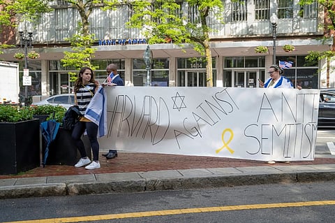 (FILES) Pro-Israeli demonstrators protest outside Harvard Yard during Harvard University's class of 2024 graduation ceremony in Cambridge, Massachusetts on 23 May 2024. Elite US university Harvard risked billions of dollars in federal funding on 14 April 2025 as it rejected a list of sweeping demands that the Trump administration said are intended to crack down on campus antisemitism. The call for changes to its governance, hiring practices and admissions procedures expands on a list Harvard received on 3 April which ordered officials to shut diversity offices and cooperate with immigration authorities for screenings of international students.