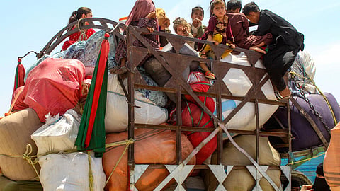Afghan refugee children board a truck loaded with their belongings as they wait for their deportation to Afghanistan, at a holding centre near the Pakistan-Afghanistan border in Chaman on April 15, 2025