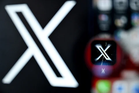 A photo shows the logo of US online social media and social networking service X - formerly Twitter - on a smartphone screen.