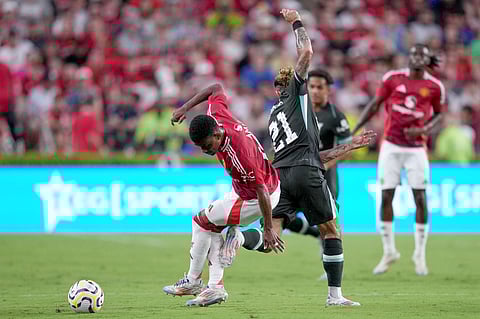COLUMBIA, SOUTH CAROLINA - AUGUST 03: Amad Diallo #16 of Manchester United battles Kostas Tsimikas #21 of Liverpool for possession during a pre-season friendly match at Williams-Brice Stadium on 3 August 2024 in Columbia, South Carolina.
