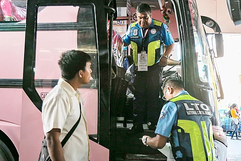 Road-worthiness check Land Transportation Office personnel inspect a passenger bus in Sampaloc, Manila, making sure the wheels turn within the bounds of safety.