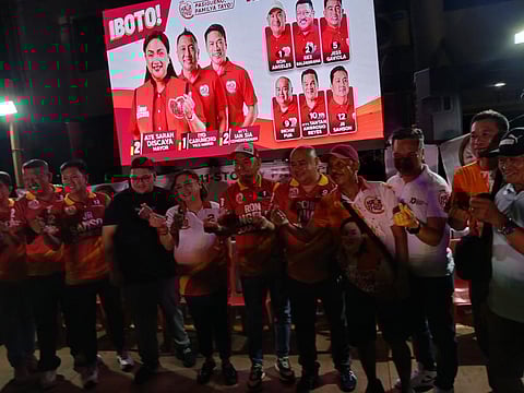 PASIG CITY mayoral candidate Ate Sarah Discaya shares a moment with her son, Gerrard (center in a black shirt) during a community caucus in Barangay Ugong.