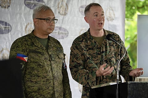 Philippine Army Brigadier General Michael Logico (L), assistant exercise director and spokesperson of the joint Philippine-US military exercise "Balikatan", and US Marine Corps Colonel Doug Krugman of the 1st Marines Expeditionary Force hold a press briefing for the upcoming joint exercise at Camp Aguinaldo in Manila on 15 April 2025.