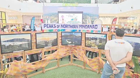 A visitor looks at the TV screens featuring different mountains of Northern Mindanao during the launch of the ‘Climb NorthMin: Limitless Mountain Adventures — Discover the Peaks of Northern Mindanao,’ Tuesday, 22 April, at the Activity Center of Centrio Ayala Mall in Cagayan de Oro City.