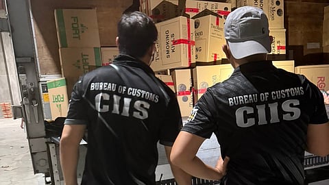 Personnel from the Bureau of Customs-Customs Intelligence and Investigation Service (BOC-CIIS) inspect smuggled cigarettes worth P83.7 million seized from a warehouse in Bocaue, Bulacan on Thursday.