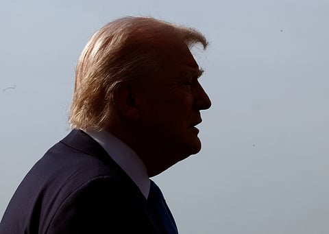 Silhouette of U.S. President Donald Trump against a pale sky as he departs the White House on 25 April 2025, ahead of his trip to Rome for the funeral of Pope Francis.