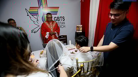 Rev. Crescencio Agbayani Jr. prays over a same-sex couple during a Holy Union ceremony at the LGBTS Christian Church in Quezon City.