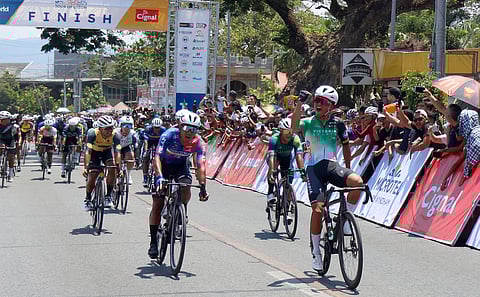 EAN Cajucom (right) of Victoria Sports celebrates while crossing the finish line of Stage 3 of the Tour of Luzon in San Juan, La Union on Saturday.