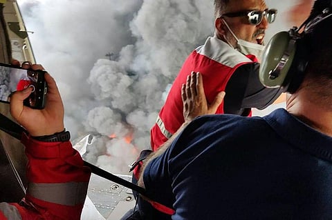 RESCUERS arrive by helicopter at the scene of an explosion that took place a day earlier at the Shahid Rajaee port dock southwest of Bandar Abbas in the Iranian province of Hormozgan. Fires were still blazing on 27 April after the massive explosion.