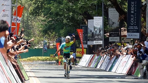 JOSEPH Javiniar of Excellent Noodles raises his arm as he crosses the finish line all by his lonesome during Stage 5 of the Tour of Luzon in Clark Field, Pampanga on Monday.
