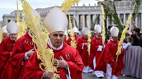 Convicted Italian cardinal Angelo Becciu at a Palm Sunday procession at the Vatican