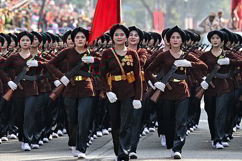 Participants march during a parade marking the 50th anniversary of the fall of Saigon and the end of the Vietnam War in Ho Chi Minh City on 30 April 2025.