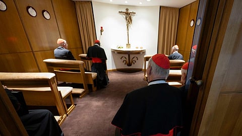 Cardinals kneel and pray before the Blessed Sacrament in a chapel near the New Synod Hall in Vatican City, seeking spiritual guidance ahead of the upcoming conclave.
