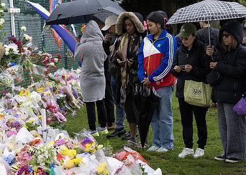 People gather at a makeshift memorial near the site where a car plowed into a crowd during the Lapu-Lapu Festival on 28 April in Vancouver, British Columbia. A 30-year-old man was arrested after driving his vehicle into the crowd at the Filipino street festival on 26 April, resulting in 11 deaths and dozens of injuries.