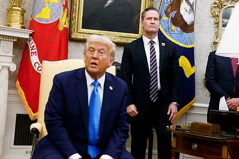 US President Donald Trump speaks during a meeting in the Oval Office, with National Security Adviser Mike Waltz standing behind him, on 4 February 2025.