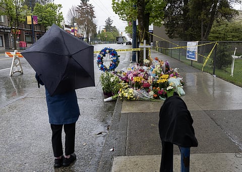 PEOPLE gather at the makeshift memorial near the site where a car drove into a crowd during the Lapu-Lapu Festival on 28 April in Vancouver, British Columbia. A 30-year-old man was detained after driving his car into the crowd at a Filipino street festival on 26 April, resulting in at least 11 deaths and multiple injuries.