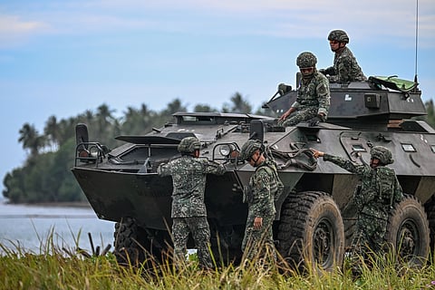 PHILIPPINE military servicemen try out an armored personnel carrier as they take part in a counter-landing live fire exercise during the annual US-Philippines joint military 'Balikatan' exercise in Rizal, Palawan 28 April.