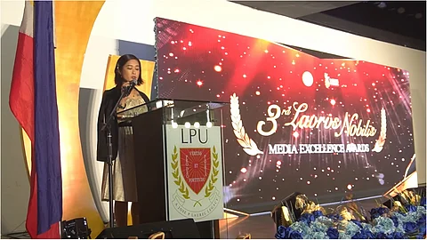 LPU Cavite Communication Program chair Mary Grace Arroyo-Vasquez delivers her opening remarks for the Laurus Nobilis Media Excellence Awards night.
