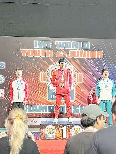 Albert Delos Santos (middle) makes heads turn in the IWF World Youth and Junior Championships in Lima, Peru.