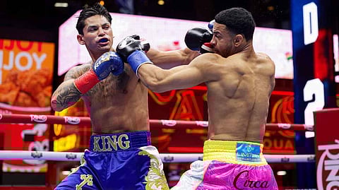 Rolly Romero (right) exchanges blows with Ryan Garcia on his way to a unanimous decision victory in their welterweight bout at Times Square in New York.