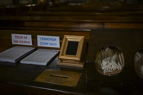 A Point of Sale (POS) device (C) is pictured at the Catholic Church of St Dionysius the Areopagite in Athens on May 4, 2025. Devout regulars attending Athens's main Roman Catholic church that honours a first-century saint have discovered a 21st-century update, with their donation box hooked up to a digital payments system.The addition of the Point of Sale (POS) device in the Cathedral Basilica of St Dionysius the Areopagite is the first in a Greek church, even though their use is common elsewhere, including in Africa.