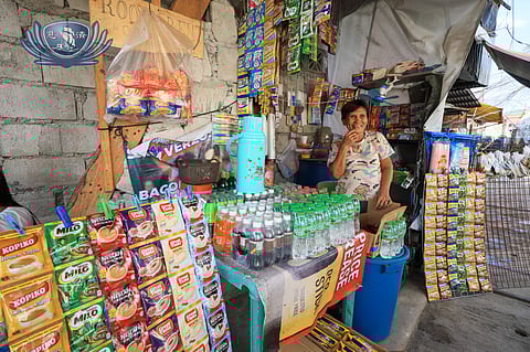 Conchita Layosa at her mini sari-sari store fully stocked with merchandise donated by volunteers of Tzu Chi Medical Foundation Philippines.
