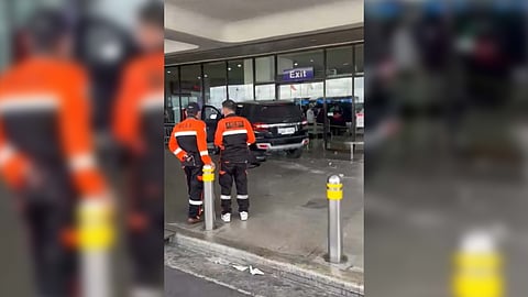 Members of the Philippine Red Cross stand beside the controversial bollards installed at the Ninoy Aquino International Airport Terminal 1 following the fatal accident which claimed two people.