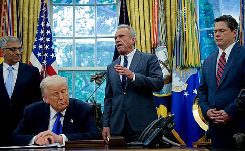 WASHINGTON, DC – U.S. Health and Human Services Secretary Robert F. Kennedy Jr. (C), accompanied by U.S. President Donald Trump (2nd-L) National Institutes of Health Director Jayanta Bhattacharya (L), and Domestic Policy Council Director Vince Haley (R), speaks in the Oval Office at the White House on May 05, 2025 in Washington, DC. Trump signed new proclamations and executive orders, including one that ends federal funding for so-called “gain-of-function” studies, which explores the use of microorganisms to alter biological functions in the aid of gene products.