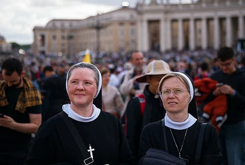 Nuns stand on St Peter's Square after black smoke billowed from a chimney over the Sistine Chapel, on the second day of the conclave, in the Vatican on May 8, 2025.
