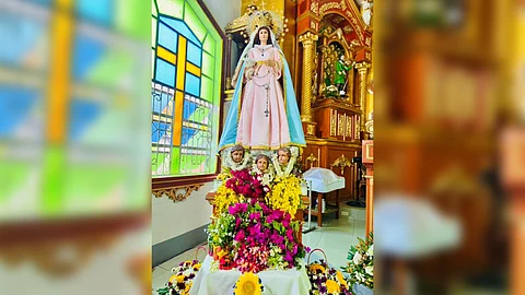 statue of the Blessed Mother filled with flowers.