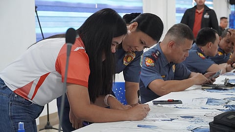 Members of the police force in Ormoc City guide the participants of the Second Quarter Joint City Peace and Order Council-City Task Force on ELCAC regular meeting for 2025 at the Ormoc City Hall and Multipurpose Hall.