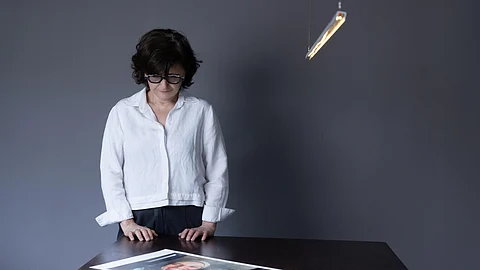 Iranian filmmaker and activist Sepideh Farsi looks at a portrait of the Palestinian photographer Fatima Hassouna, who was killed in the bombing of her house in the Gaza Strip