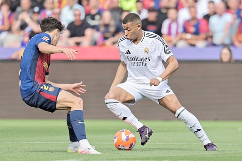 Kylian Mbappe attacks the defense to lead Barcelona to a thrilling 4-3 victory over Real Madrid in the La Liga on Sunday.