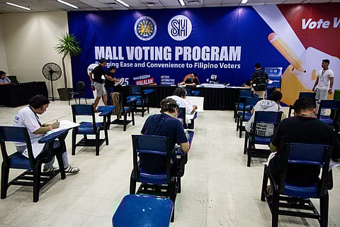 Democracy in motion Voters quietly fill out their ballots early Monday at SM Manila, where the midterm polls got off to an orderly start.