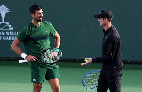 Novak Djokovic (left) of Serbia and his coach Andy Murray working on his serve during a practice session at the BNP Paribas Open at Indian Wells Tennis Garden on March 6, 2025 in Indian Wells, California.