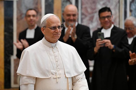 Pope Leo XIV smiles as members of the Lasallian community applaud during a Vatican audience recognizing their contributions to education and ministry.