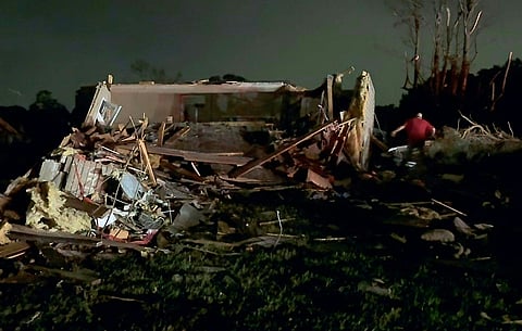 A resident searches through the wreckage of a home destroyed by a tornado in Laurel County near London, Kentucky, on 17 May 2025, following deadly storms that killed over 20 people across Kentucky and Missouri.
