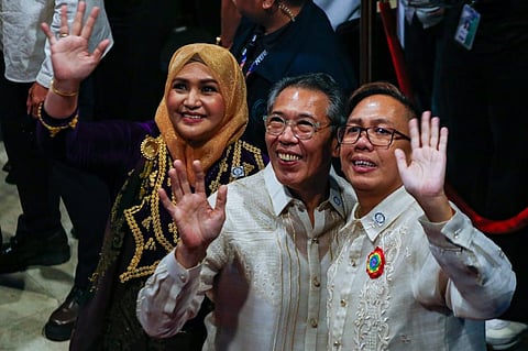 TOPNOTCHERS: Newly-proclaimed representatives from vote-leading party-list Akbayan, led by Chel Diokno, wave at Manila Hotel on Monday.